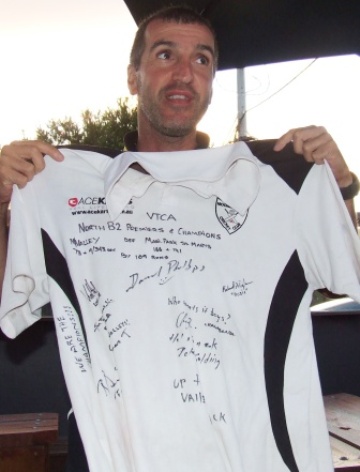 Skipper Jim Polonidis with a club shirt signed by the victorious players.